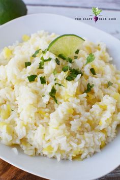 white rice with lime and cilantro served on a white plate, ready to be eaten