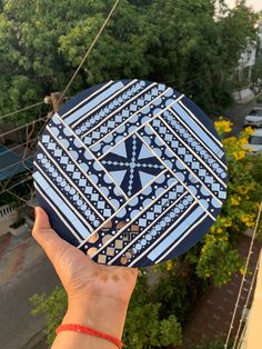 a hand holding up a blue and white plate