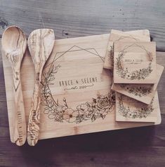 engraved wooden utensils and napkins on a wood board with the words fenneson & loom printed on them