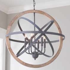 a circular chandelier with candles hanging from it