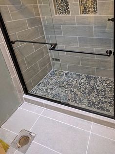 a walk in shower sitting next to a toilet