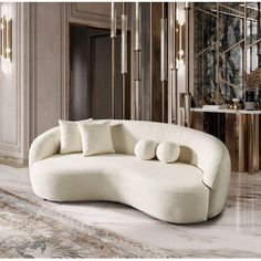 a white couch sitting on top of a marble floor