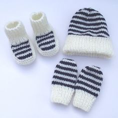 a knitted hat, mittens and booties are laying next to each other