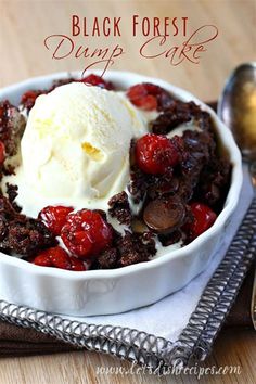 black forest dump cake with ice cream and cherries in a white bowl on a wooden table