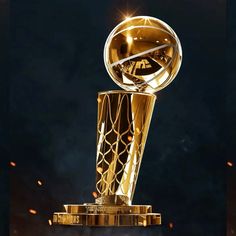 the golden basketball trophy is in front of a black background