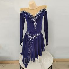 a blue dress with white sequins on it