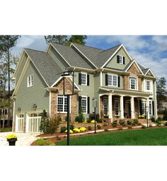 a large house with lots of windows and brick sidings on the front of it