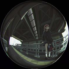 a man sitting on top of a metal railing next to a building with lots of windows