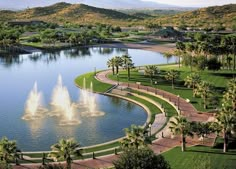 an aerial view of a pond with fountains in it