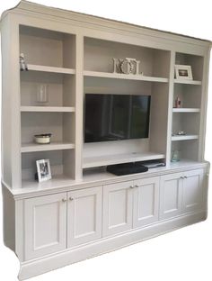 a white entertainment center with built in shelves