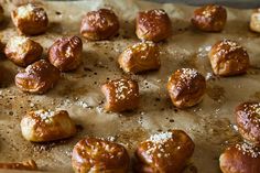 there are many croissants that have been made on the baking sheet with powdered sugar