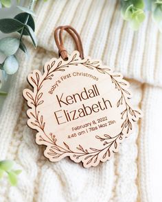 a personalized wooden ornament for a baby's first christmas is shown