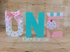 the letter n is decorated with polka dots and a pink bow