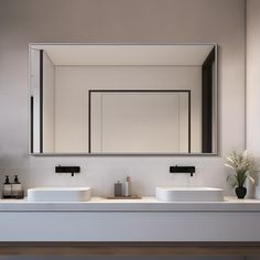 a bathroom with two sinks and a mirror on the wall next to each other in front of a plant