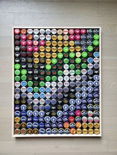 an art piece made out of beer bottle caps on a wooden floor with white walls