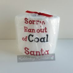 a white box with red writing on it and a ribbon tied around the top that says sorry ran out of coal santa