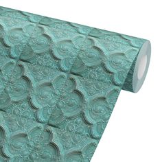 a roll of green paper with intricate designs on it