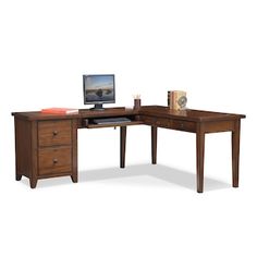 an l - shaped desk with two drawers and a computer monitor