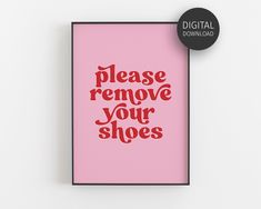 a pink poster with the words please remove your shoes in red on it, next to a black button