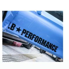 a blue truck with the words l b performance on it's side and black star decals