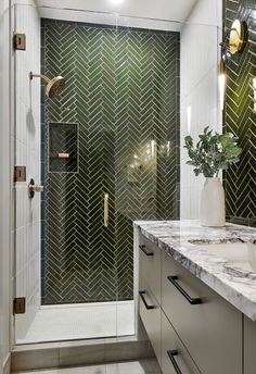 a bathroom with a marble counter top and shower stall next to a large mirror on the wall