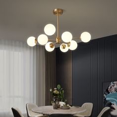 a dining room table with chairs and a chandelier hanging from it's ceiling