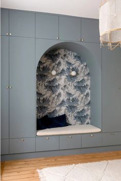 a room with blue cabinets and a white rug