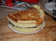 a cake sitting on top of a wooden cutting board