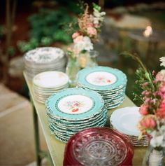 a table with plates and vases on it