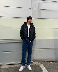 a man standing in front of a garage door