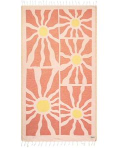 an orange and white rug with sunflowers on the front, in different colors