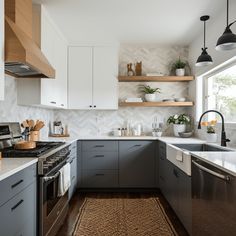 a kitchen with gray cabinets and white counter tops, an area rug on the floor