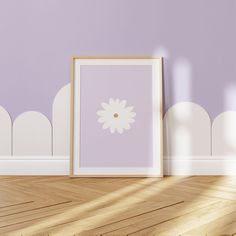 a white frame sitting on top of a hard wood floor next to a purple wall