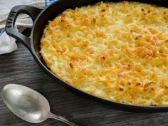 a casserole dish with macaroni and cheese in a cast iron pan