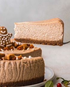 a piece of chocolate cheesecake being lifted from a cake plate with a slice taken out