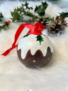 a decorated christmas ornament sitting on top of white fur