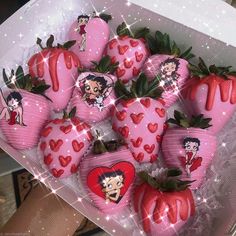 a box filled with lots of pink strawberries