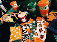 several halloween socks and coffee cups on a table