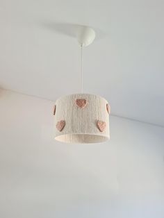 a light fixture with hearts hanging from the ceiling