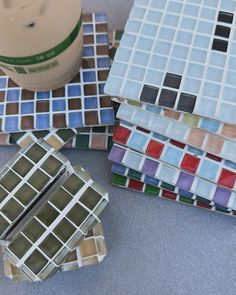 several different colored glass tiles sitting on the floor