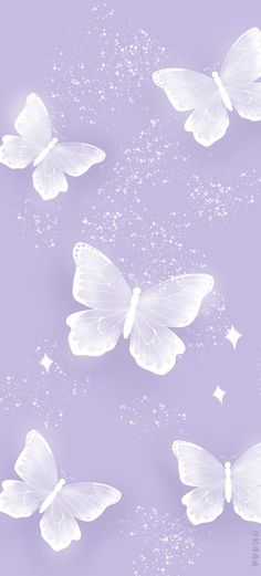 three white butterflies flying in the sky with sparkles on them and stars around them