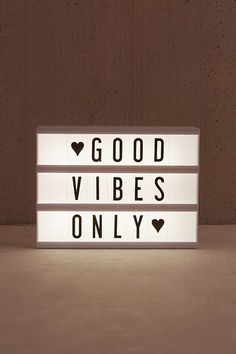 a light up sign that says good vibes only with hearts on the front and back