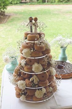 a wedding cake made out of doughnuts and flowers