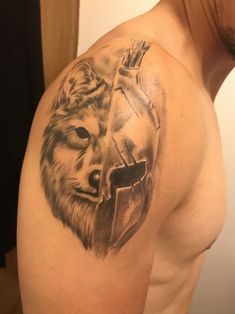 a man with a lion tattoo on his arm