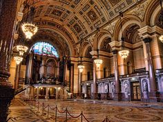 the inside of an ornate building with chandeliers