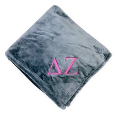 a black and pink blanket with the letter z on it's front end, sitting on top of a white surface