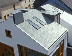 an aerial view of a house's roof and dormer windows with tiled roofs