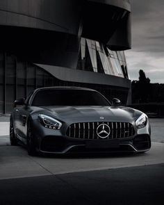 a mercedes sports car parked in front of a building