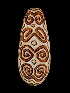 an intricately carved wooden object on a black background