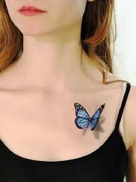 a woman with a butterfly tattoo on her chest